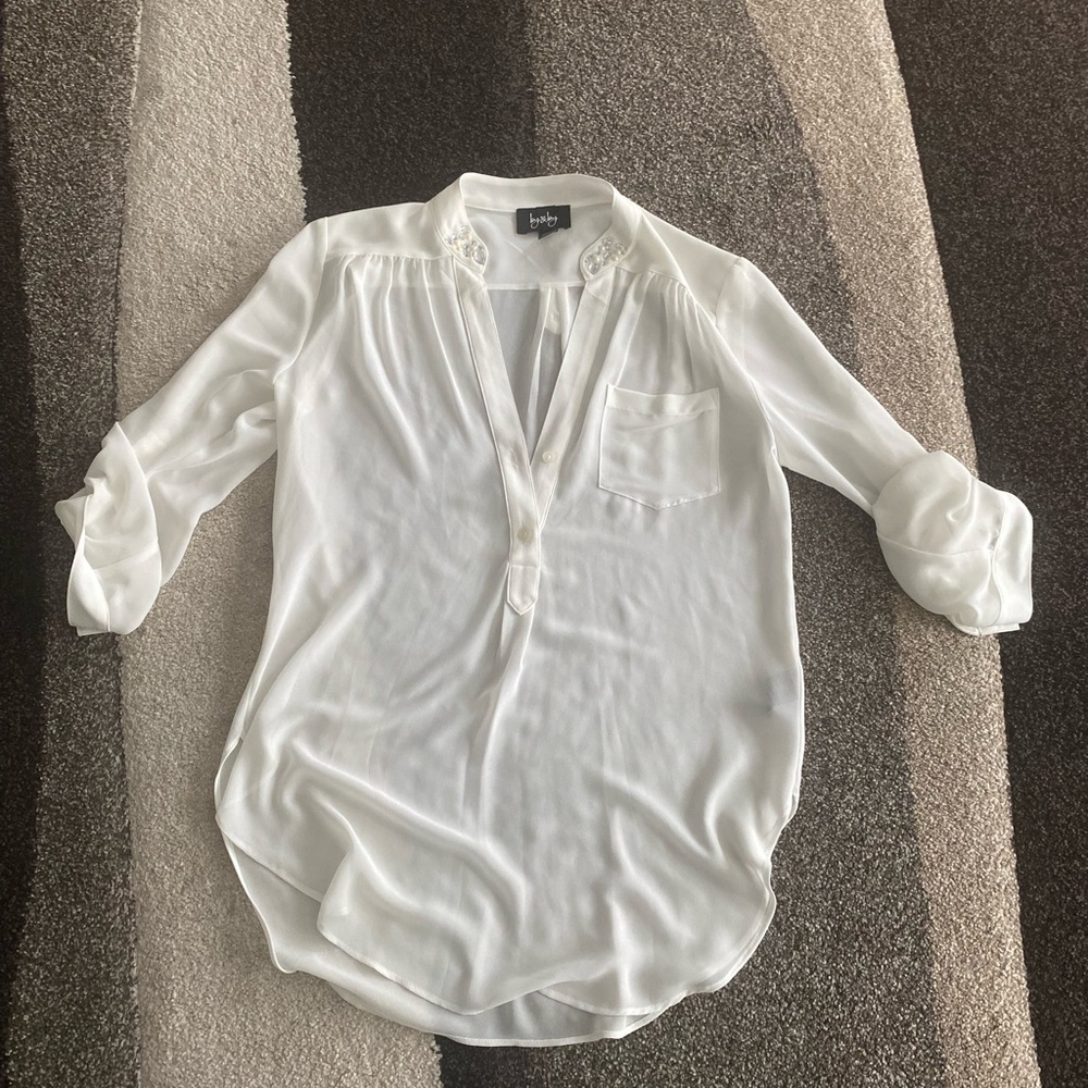 By by white long sleeve shirt